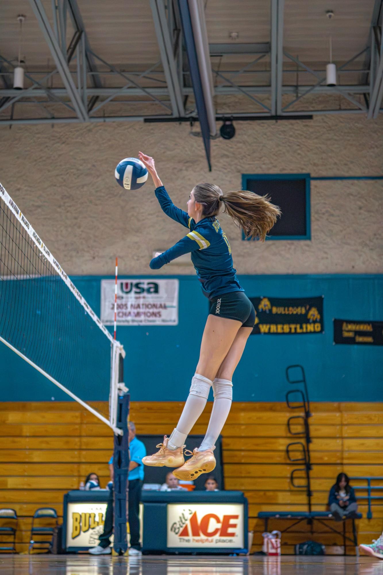 Alhambra player leaps to hit at the net