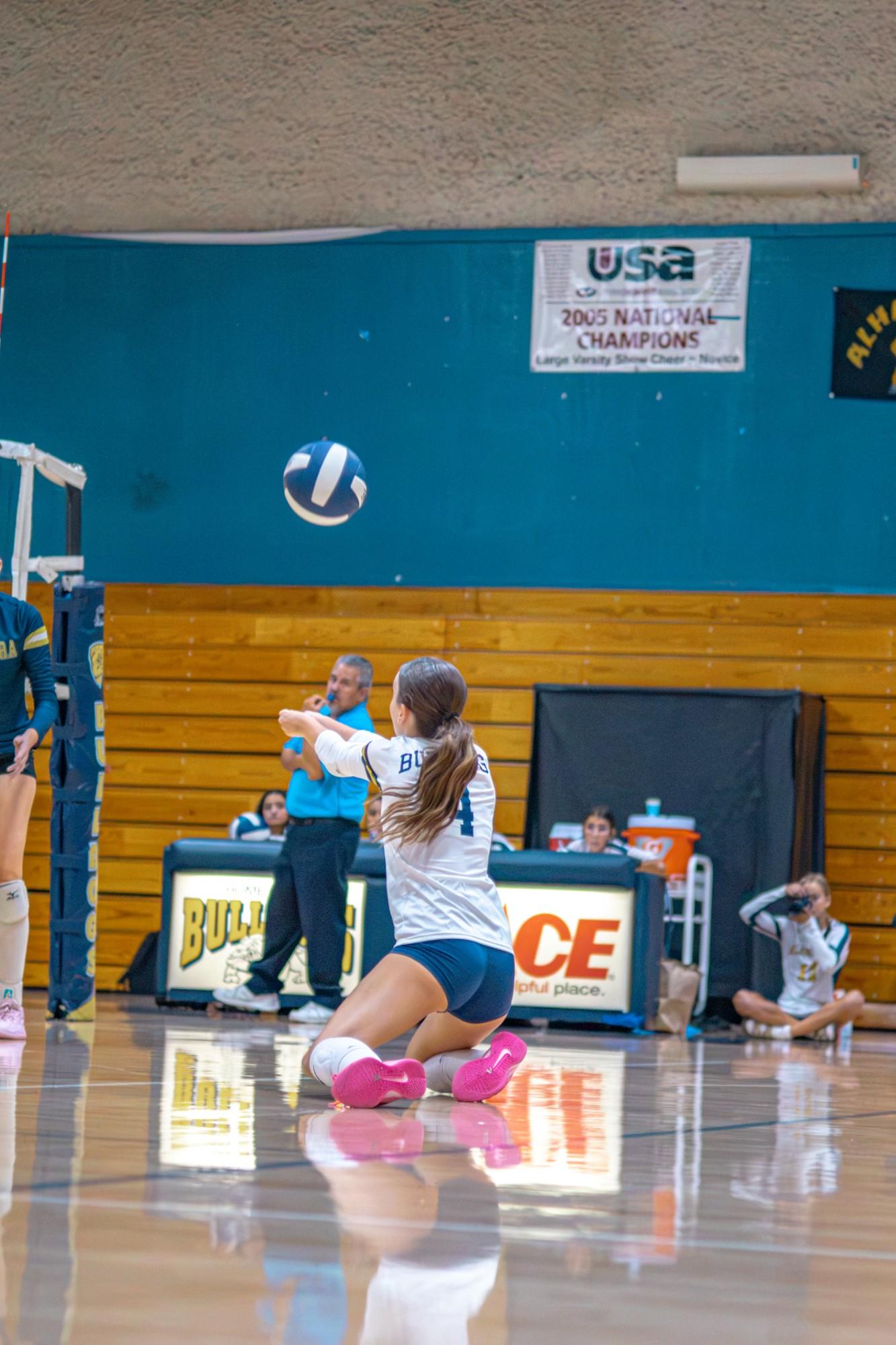 Alhambra libero #4 drops to her knees to dig the ball
