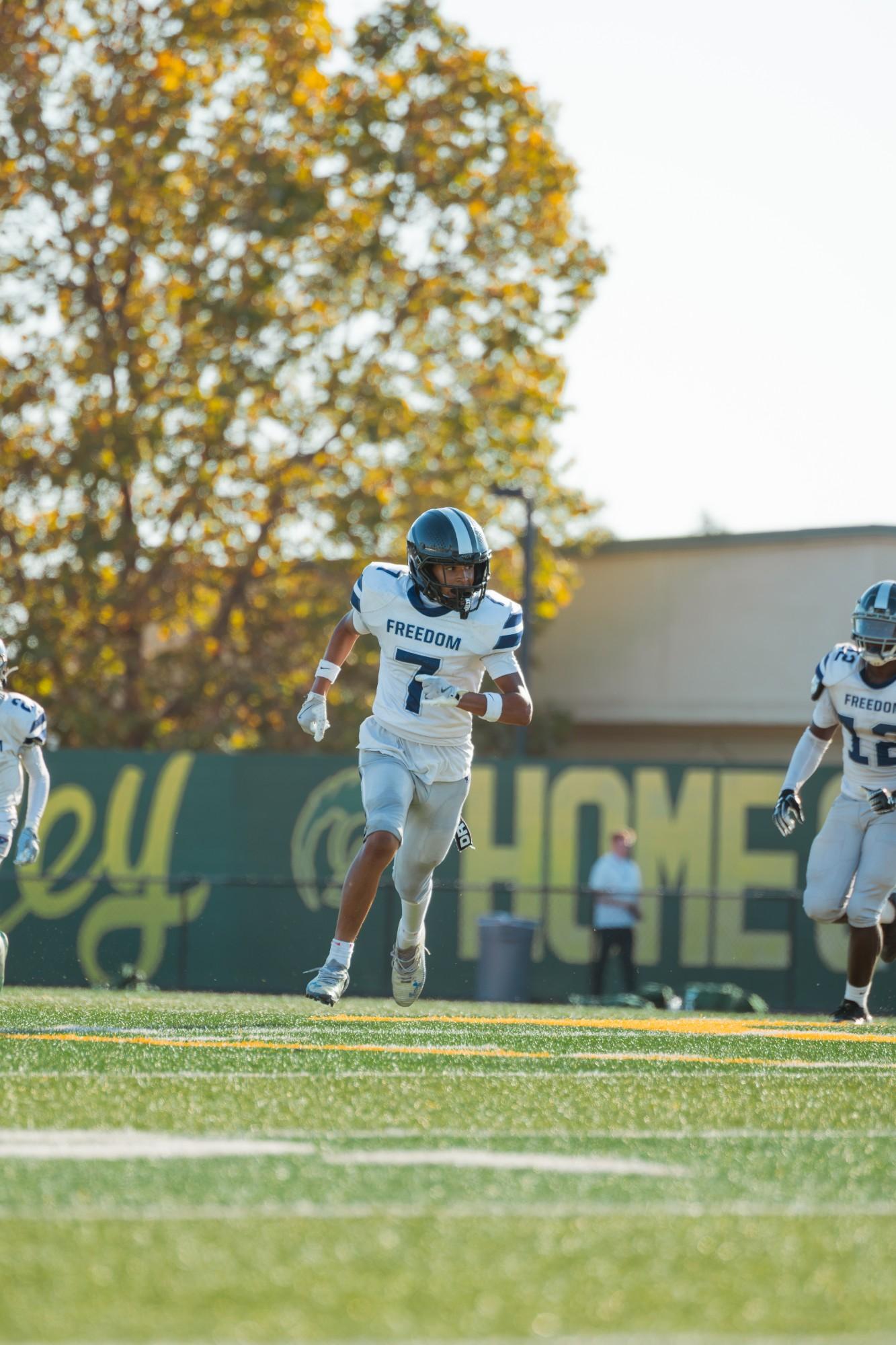 Freedom #7 sprints downfield in a white away jersey