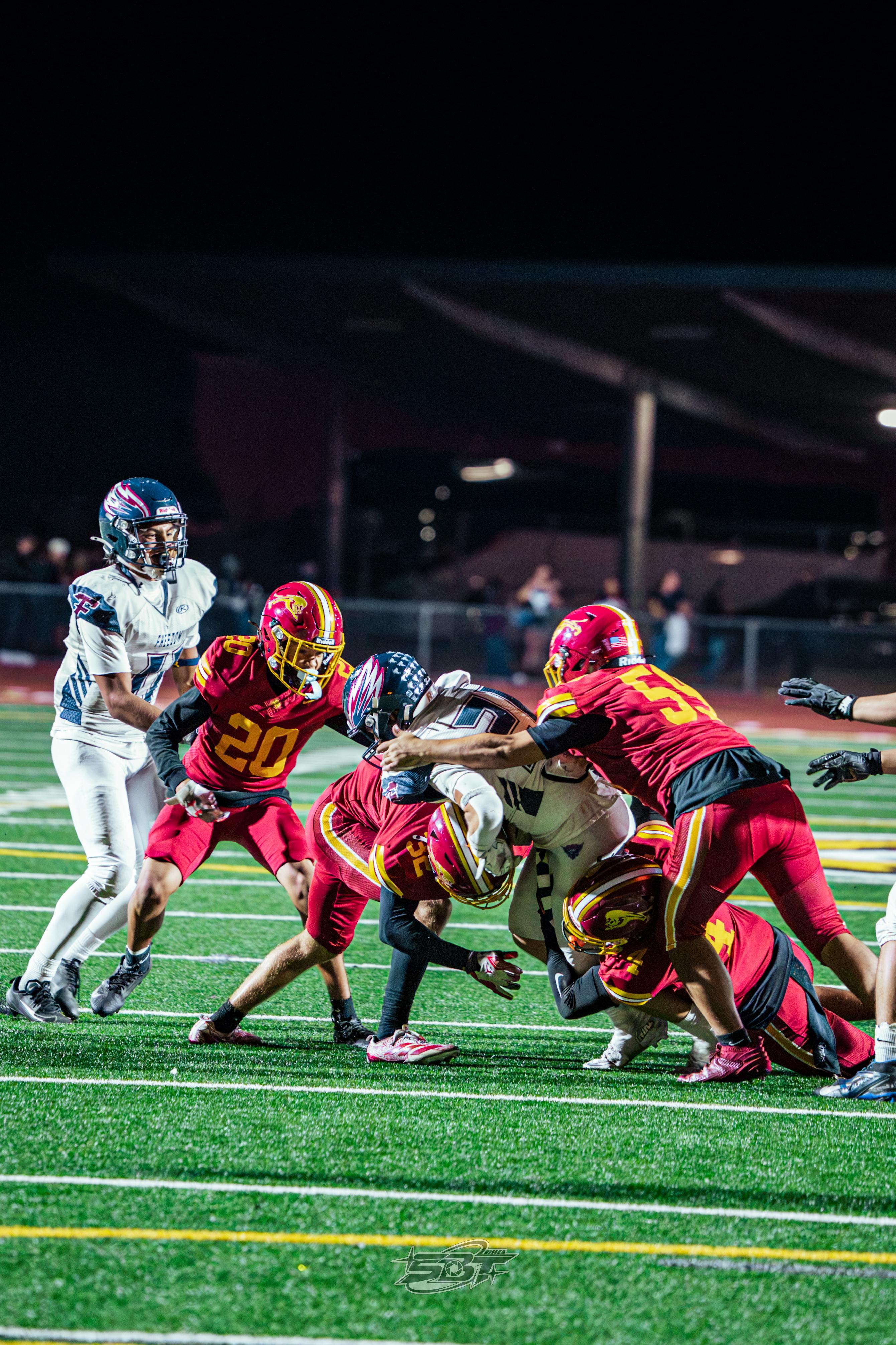 Freedom and Liberty players in a pile after the play