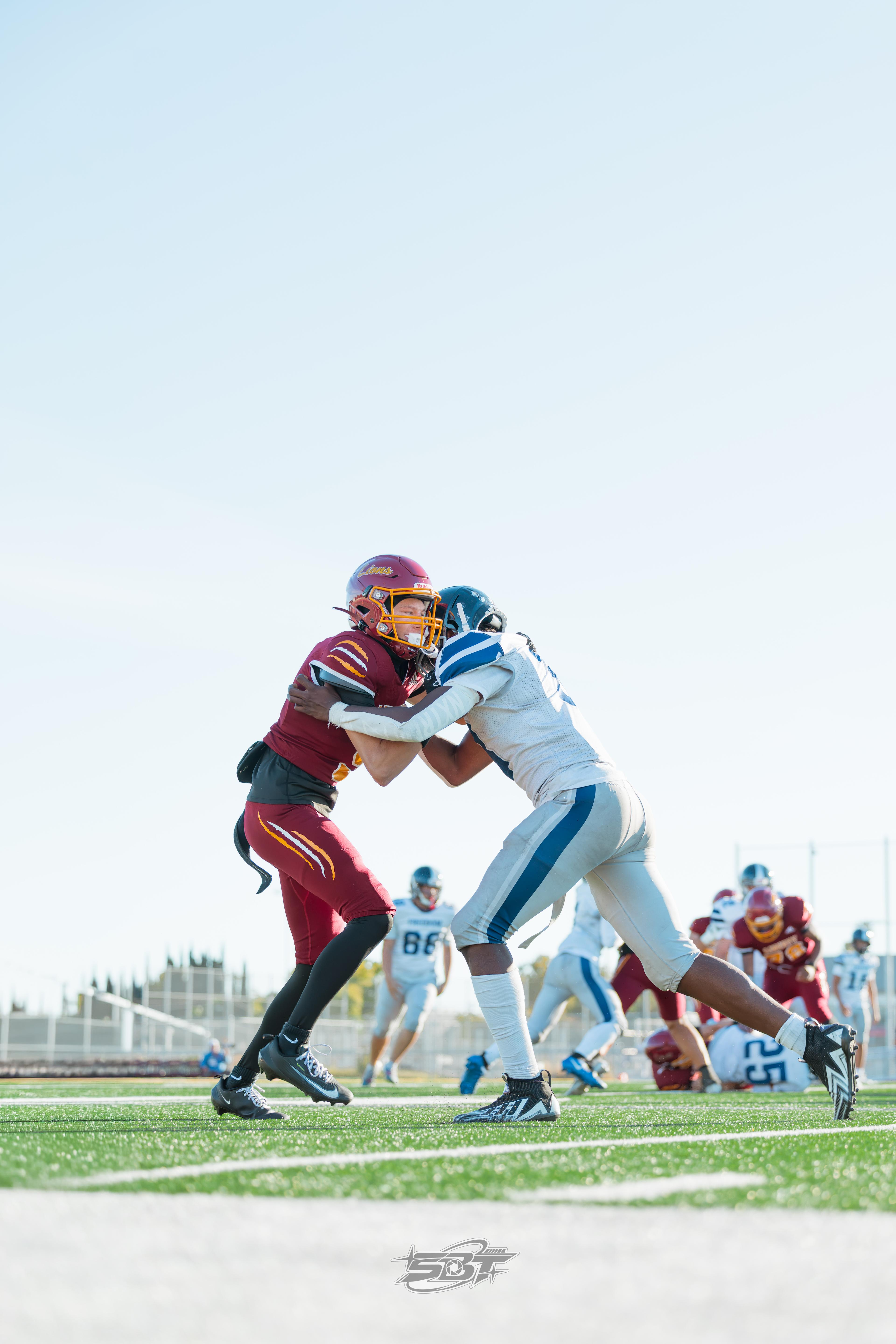 Liberty defender tackling a Freedom ball carrier