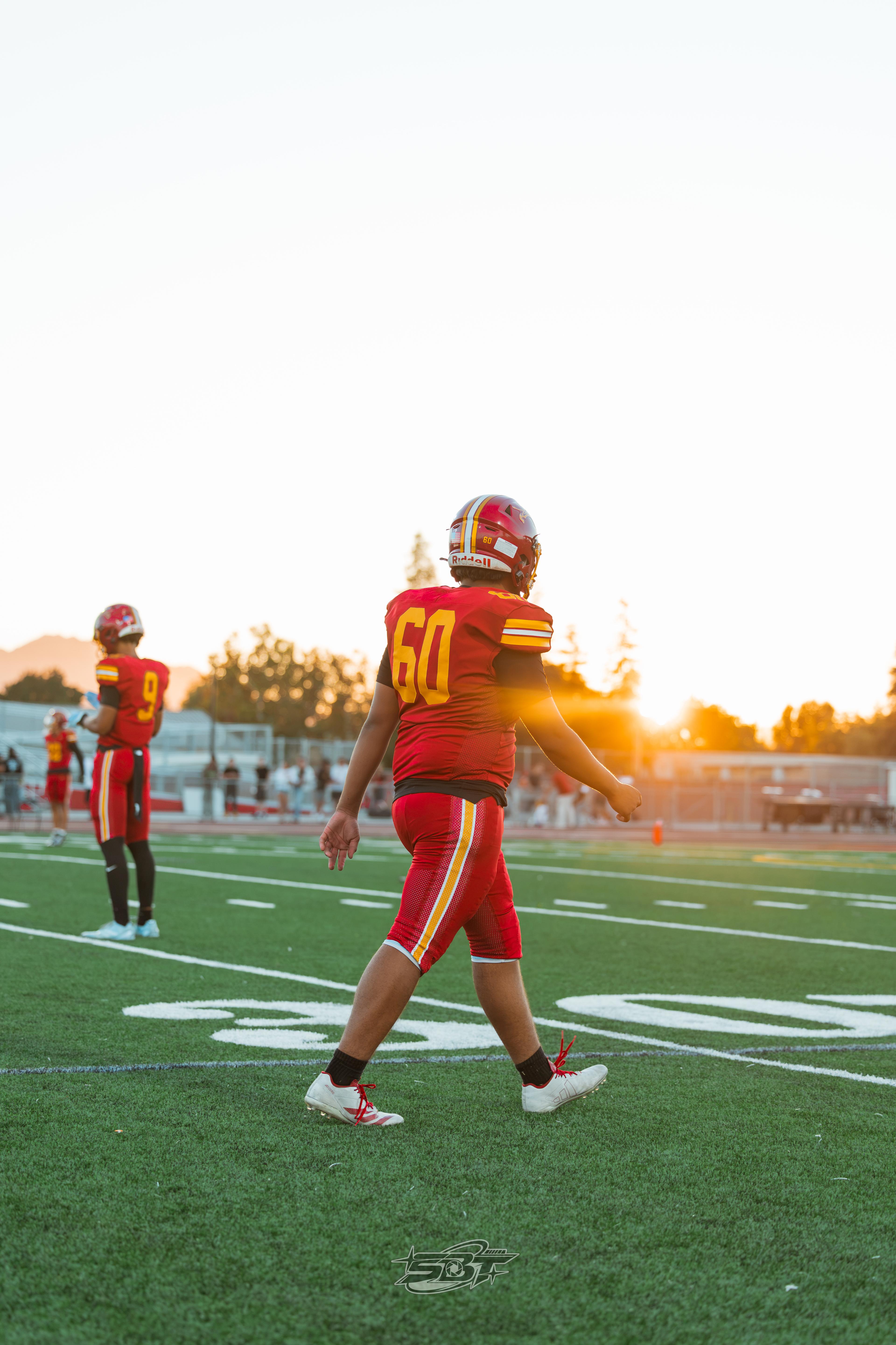 Liberty players walking the field at sunset