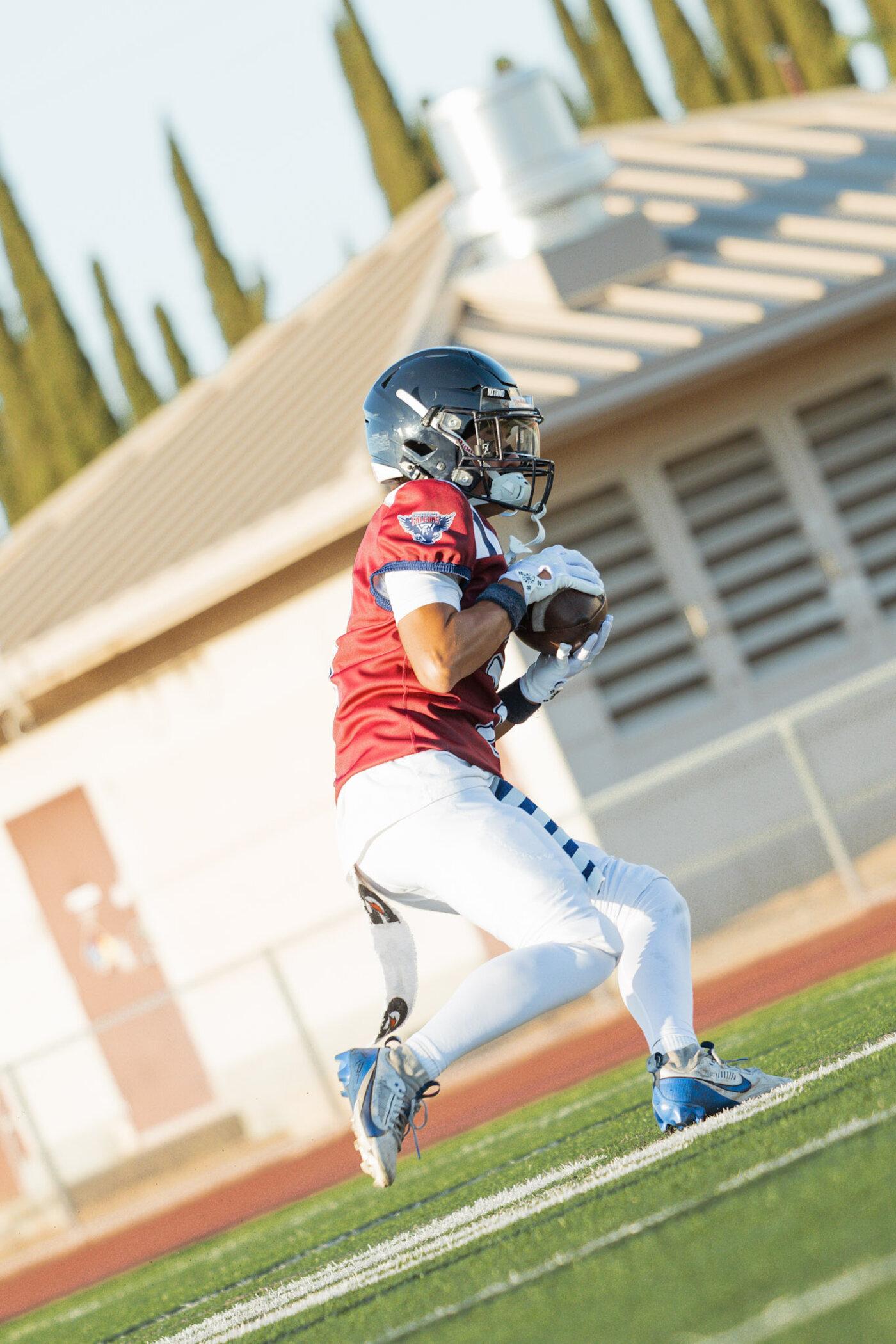 Freedom Falcons receiver going up for a catch