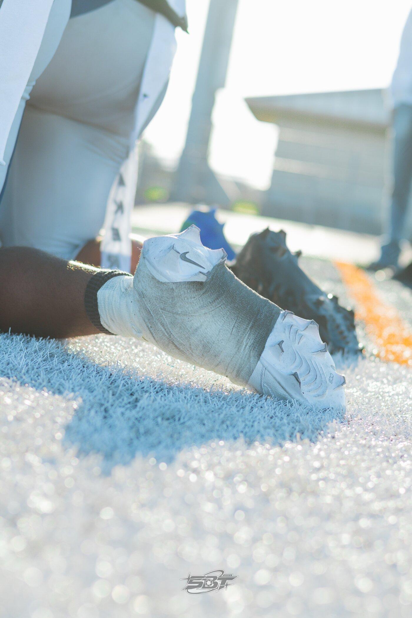 Detail shot of a player's cleats on the turf