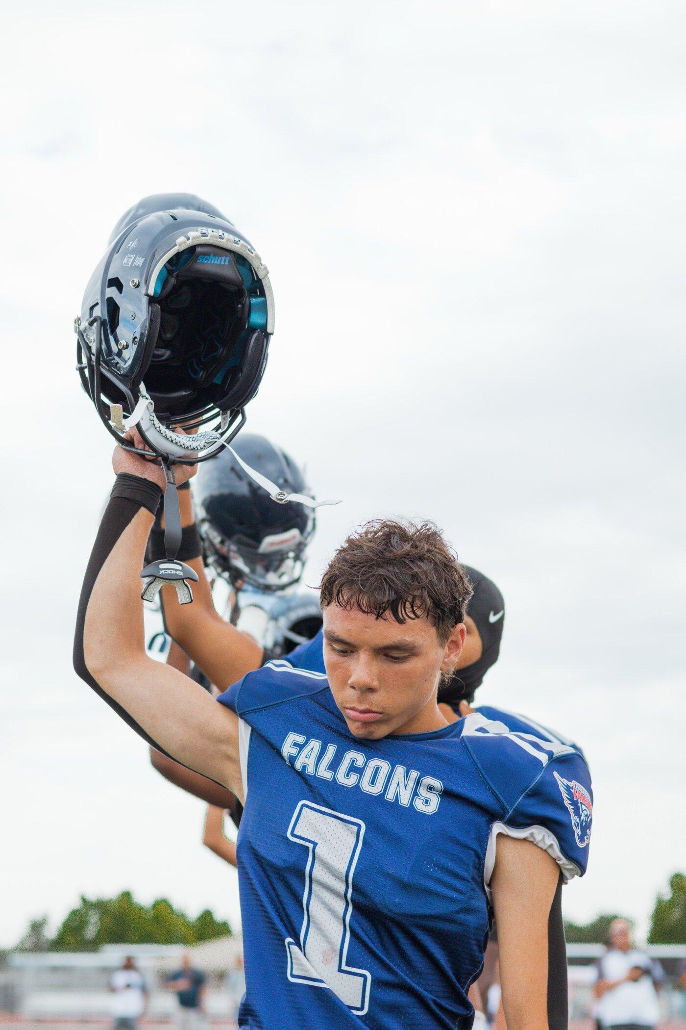 Freedom Falcons player standing with helmet on, back turned