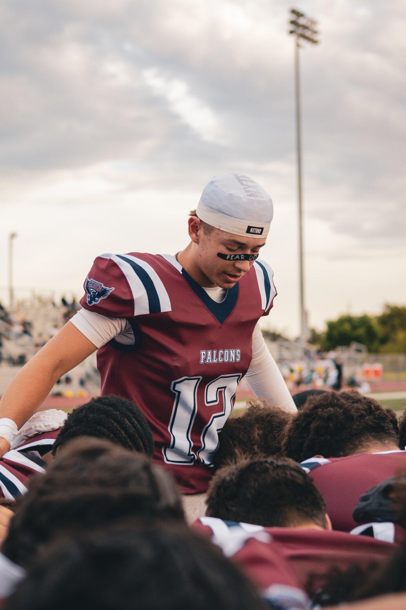 Freedom Falcons huddled together on the field