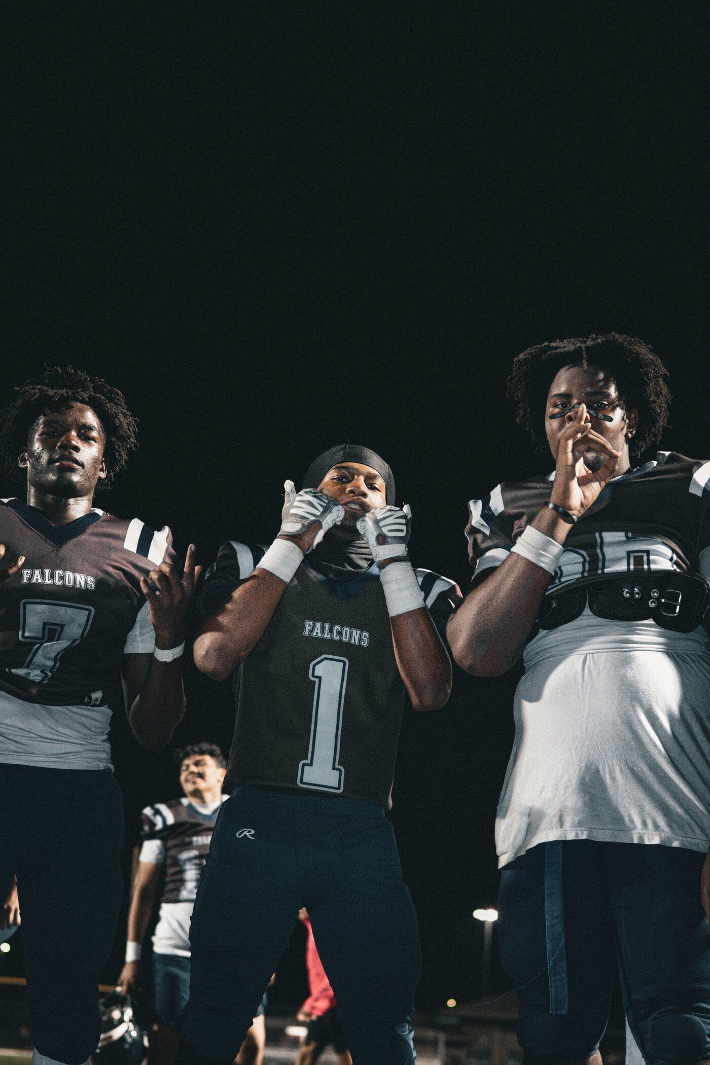 Freedom Falcons players together under the lights