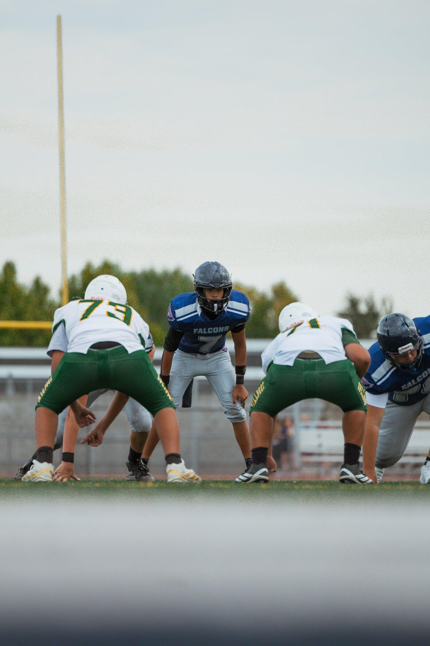Freedom JV quarterback at the line before the snap