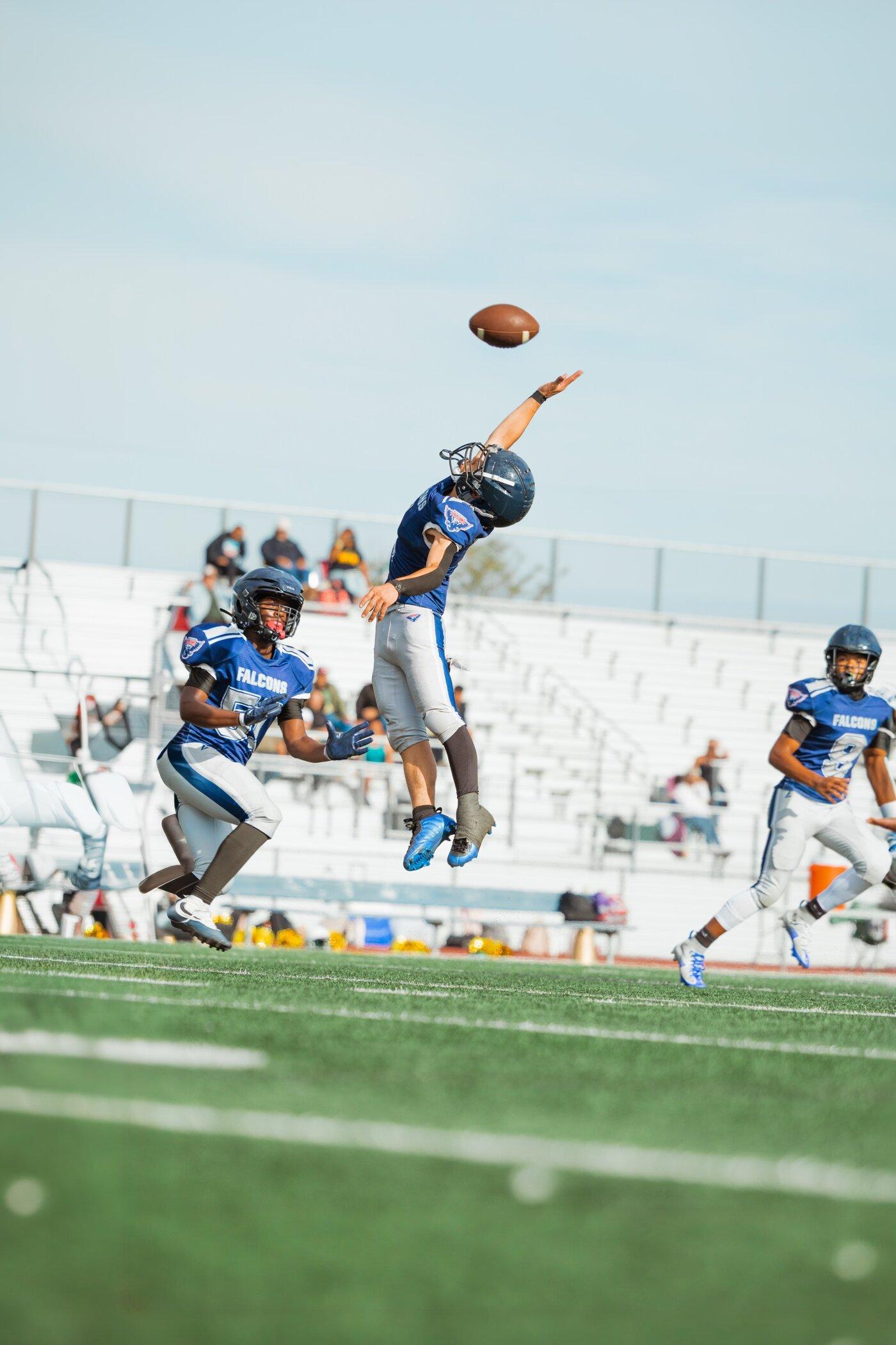 Freedom JV Falcons receiver reaching for a catch