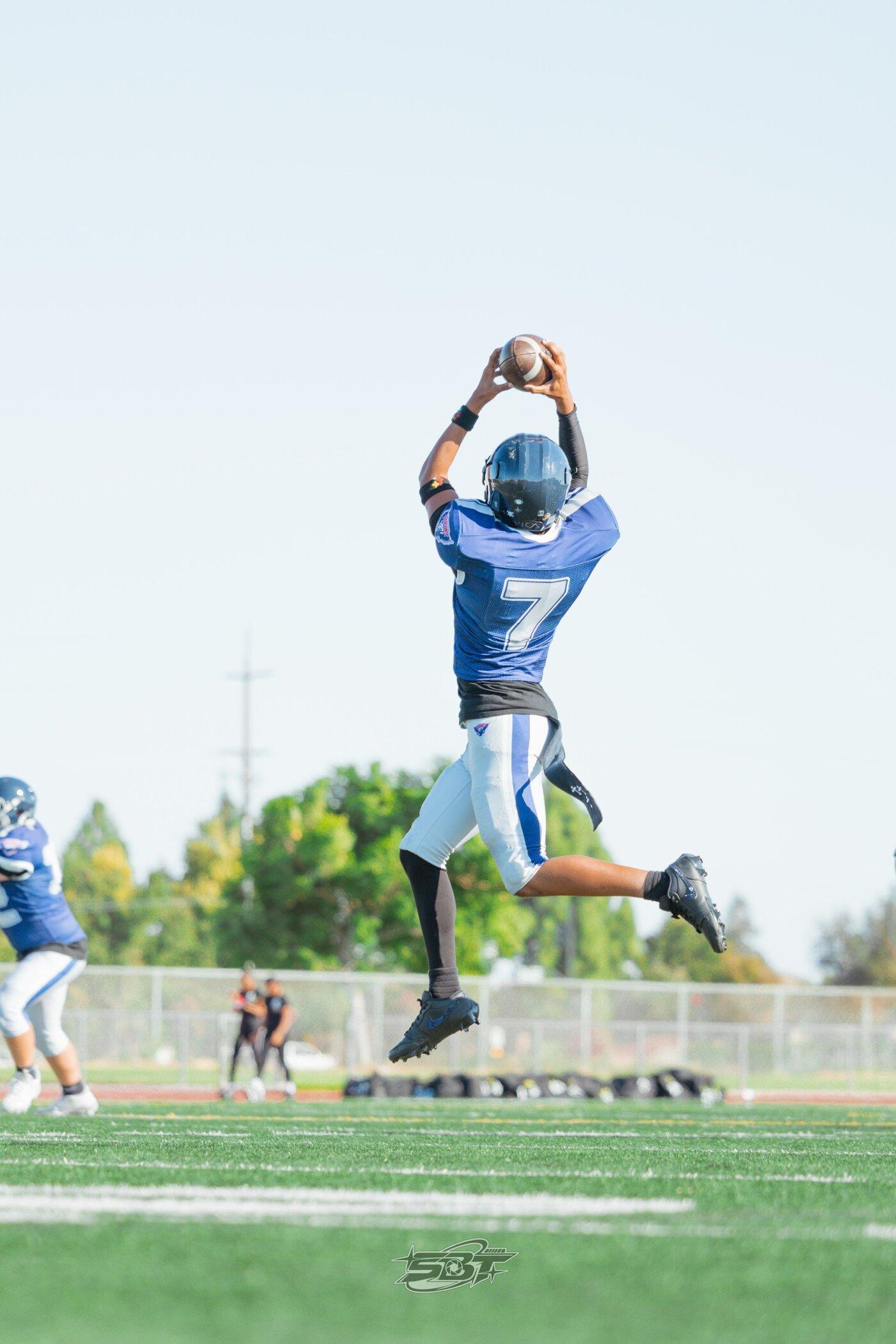 Freedom JV player leaping high for a catch