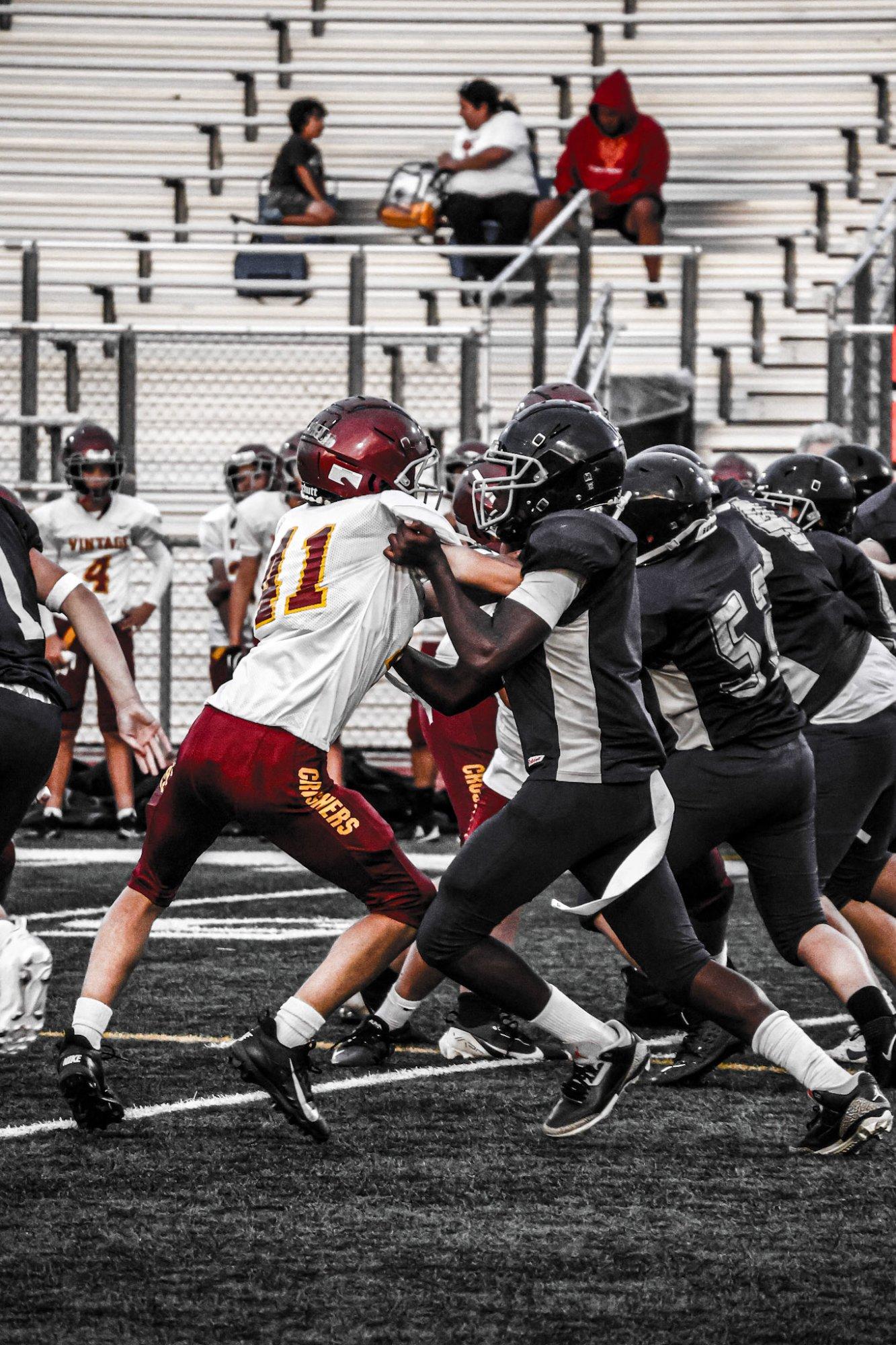 Freedom frosh football player blocking during a scrimmage against Vintage